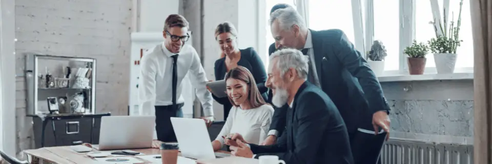Senior leaders reviewing information together, representing organisations seeking clarity and direction during CRM transition.