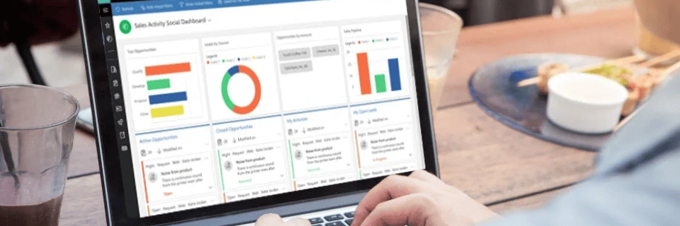 CRM dashboard analytics displayed on laptop with performance metrics